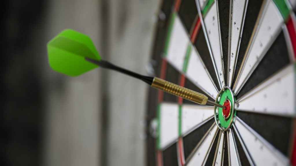 a typical darts game with dart in the bullseye